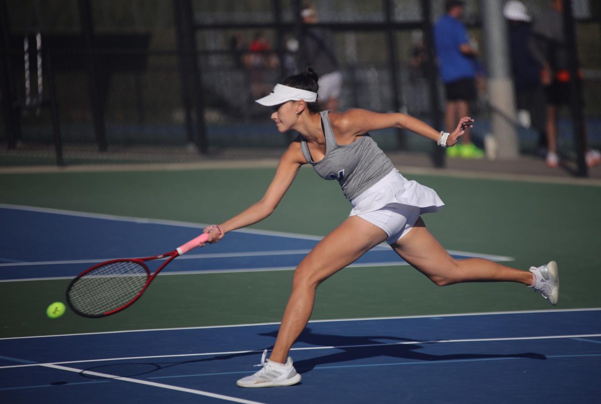 Arm out, senior Audri Brizendine runs for the ball. 