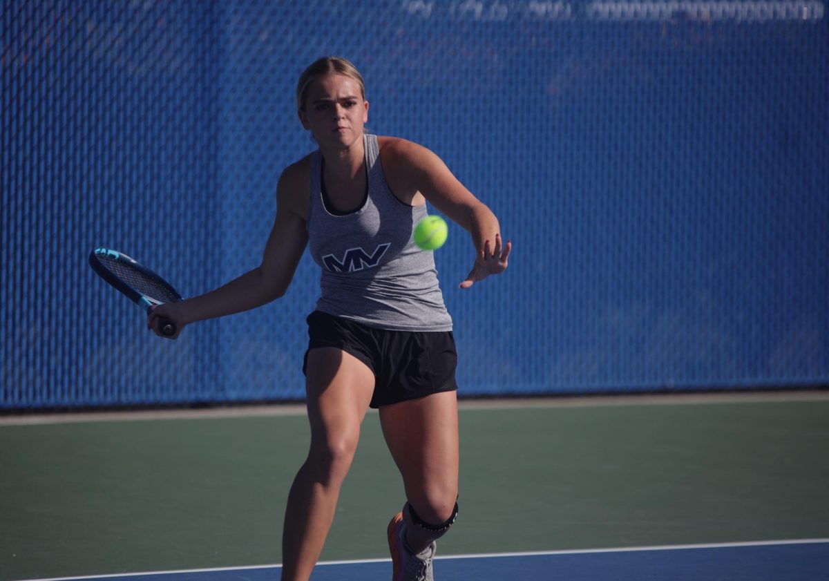 Eyes on the ball, senior Logan Miller gets ready to return to her opponent.