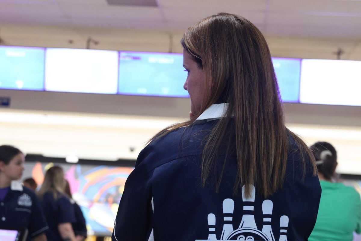 Assistant coach Amy McClure watches as the Bowling team competes in the Cat Cup Bowling tournament. 