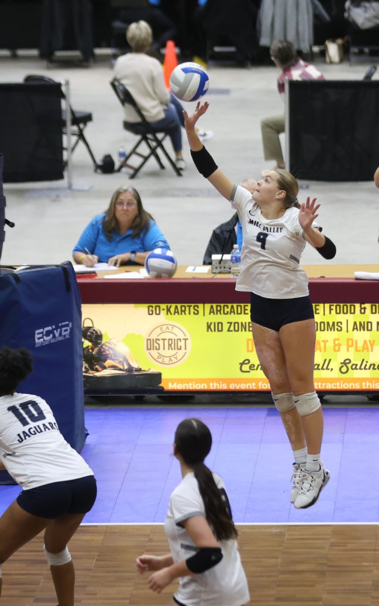 Reaching toward the ball, senior Brekhan Waters looks to hit the ball against Garden City.