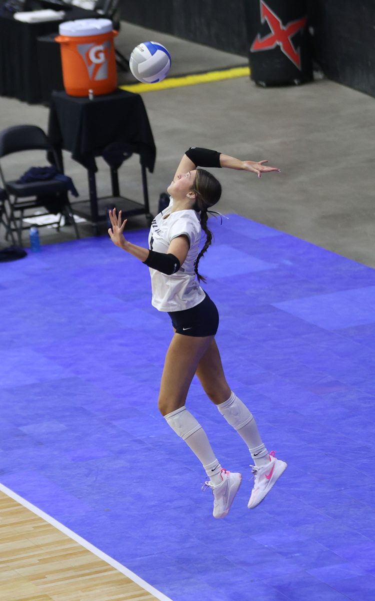 Focusing on the ball, senior Ashlyn Blazer serves the ball in the second set against Garden City.