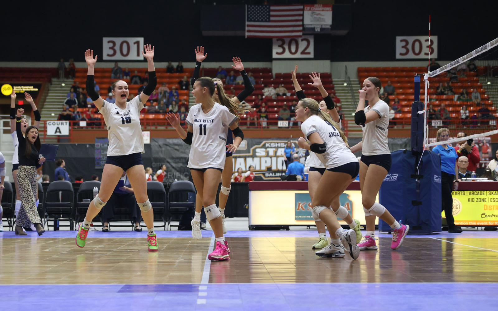 The Jags celebrate after junior Ella Florez gets a kill against Olathe West in the first set.