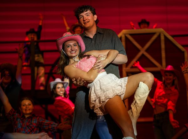 Dipping in Willards arms, played by senior Blake Gray, Rusty, played by senior Allyson Makalous, smiles out at the crowd