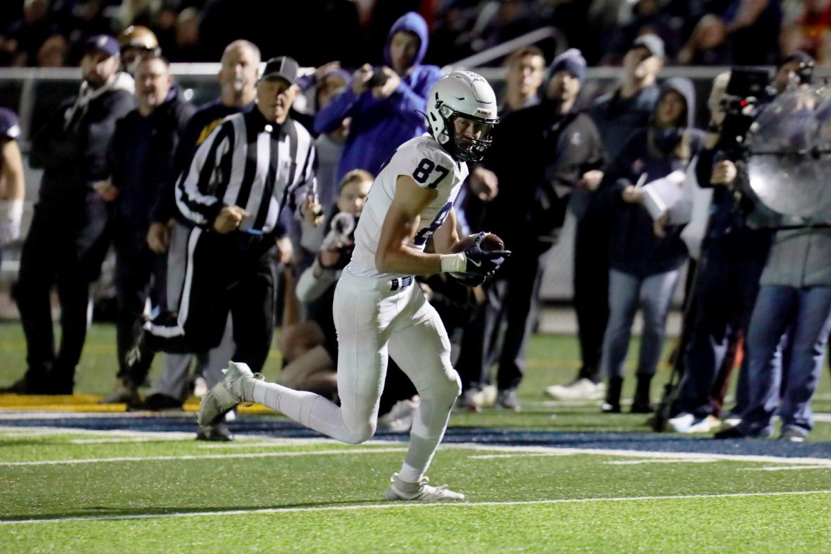 Running with the ball, senior Issac Sauder looks towards the endzone. 