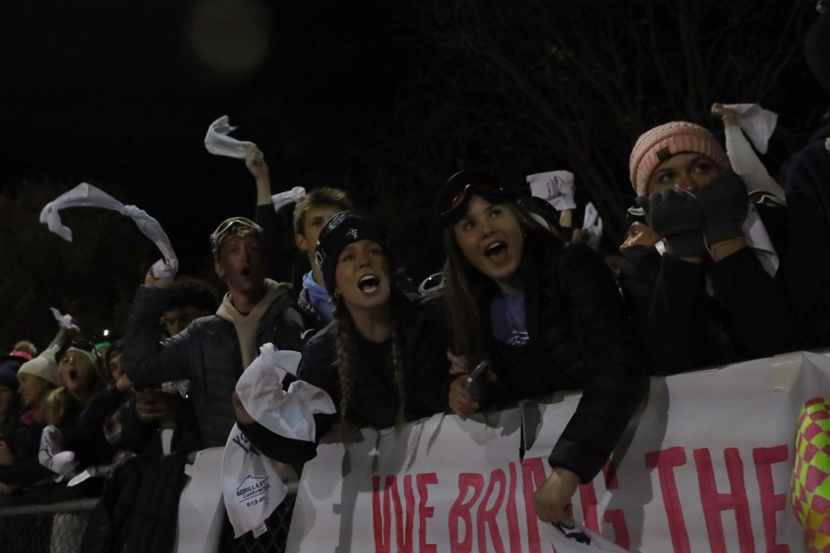 Cheering, seniors Josie Benson, Lauren Welch and Gracie Kurzejeski watch the intense game.