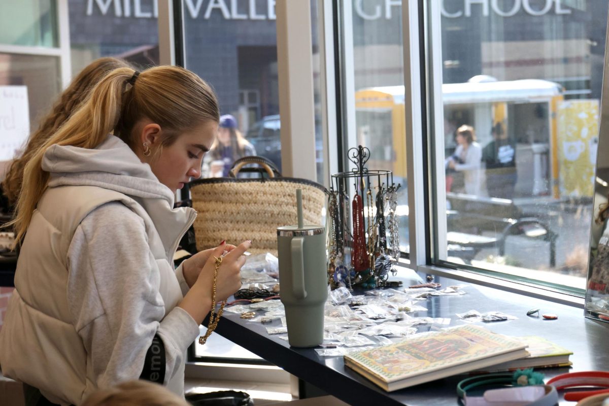 Looking at a necklace, junior Claire Cooper browses the jewelry section. 