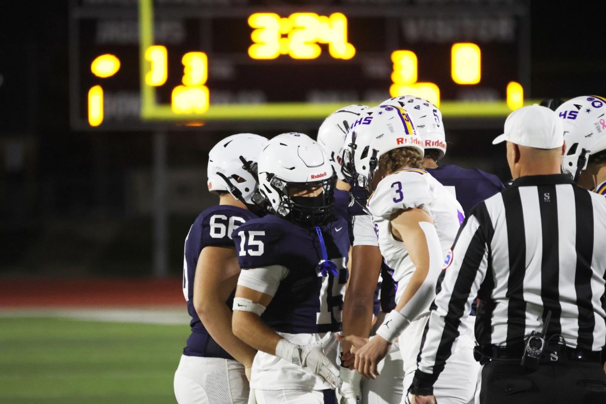 Senior Andy Watts shakes hands with the opposing team before the game begins. 