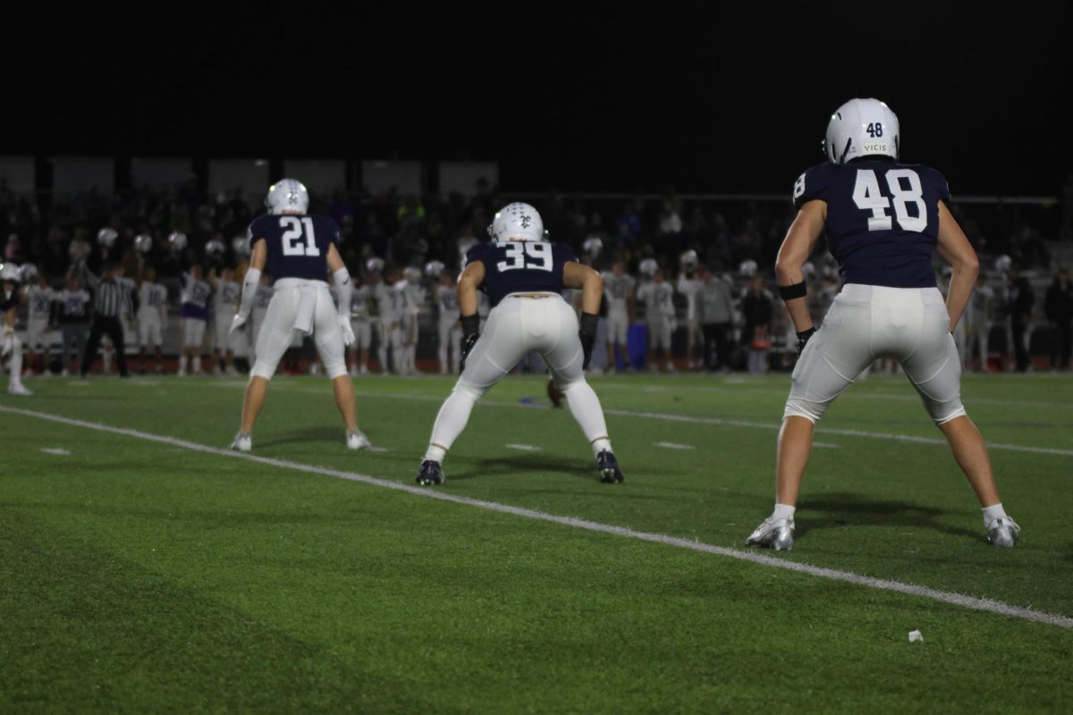 Senior Clayton Sondgeroth, sophomore Ryder Farley, and junior Jaxon Garcia line up for kickoff. 