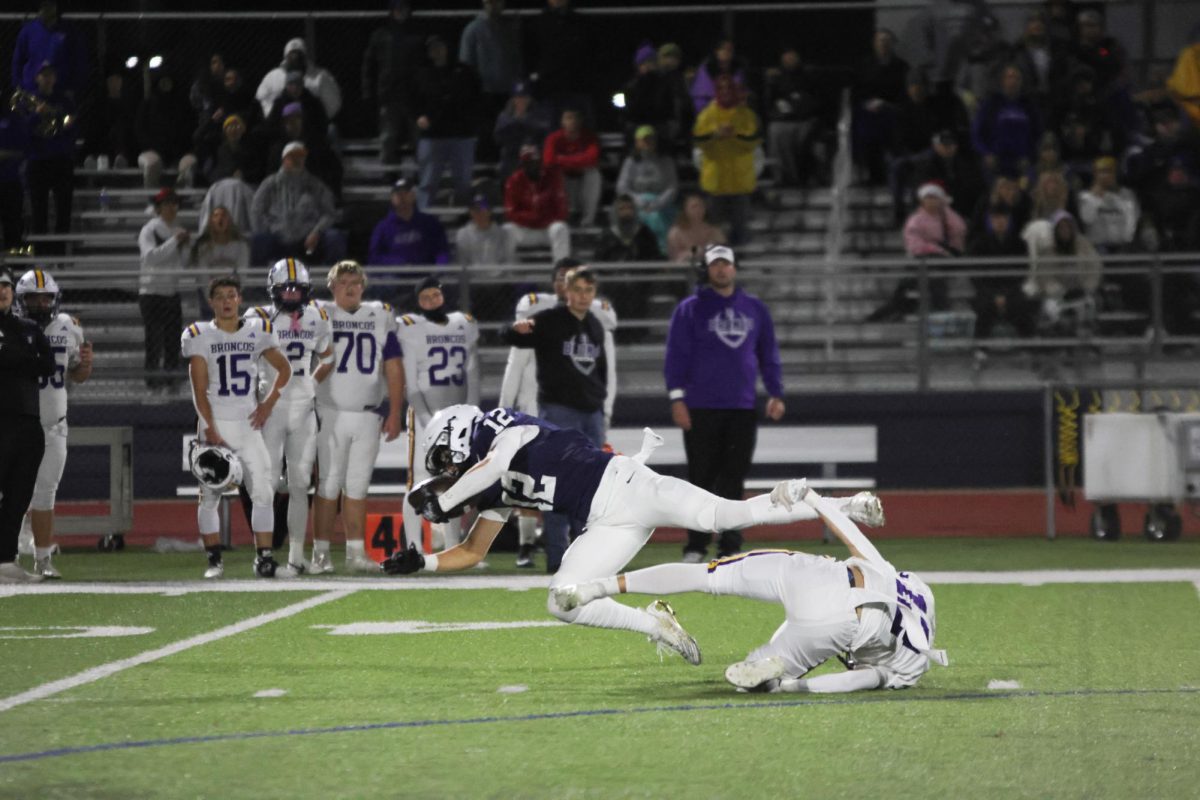 Junior Blake Jay jumps out to further extend his yards on the play. 