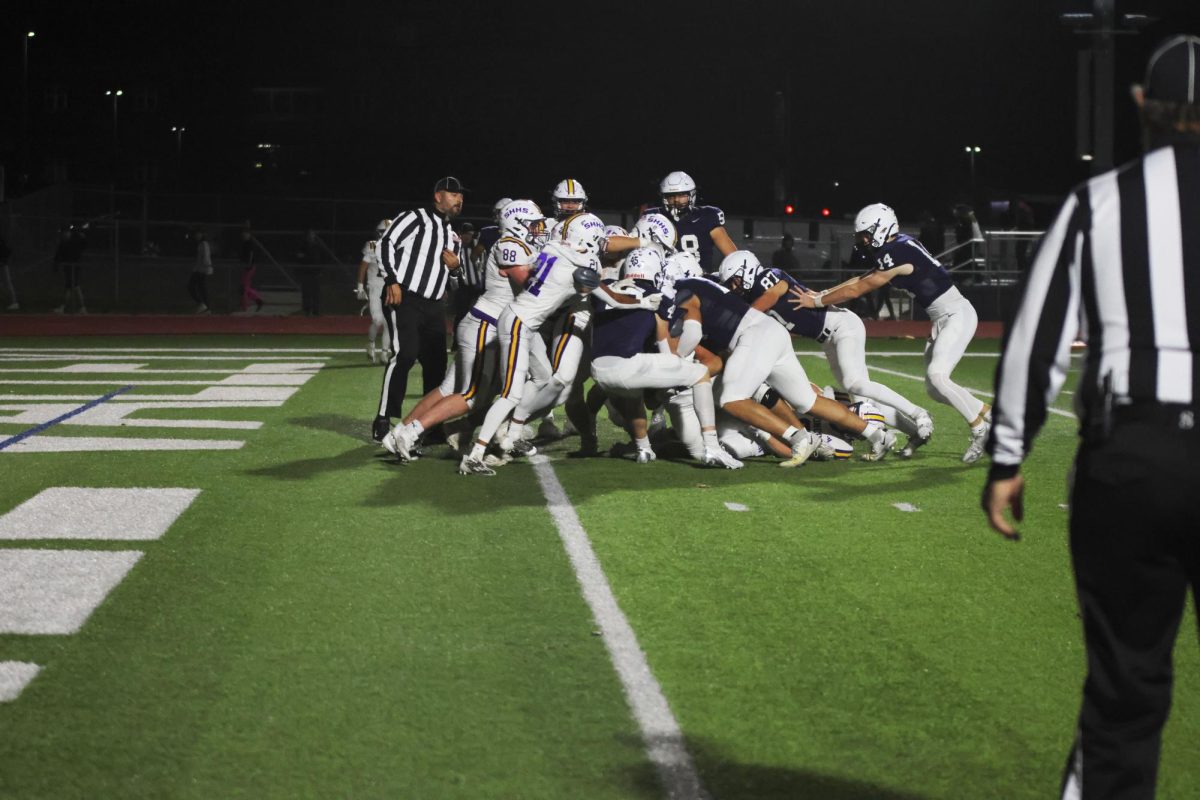 Mill Valley's offense attempts to push the ball carrier into the endzone. 