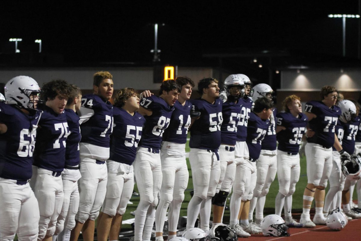 Celebrating a Jaguar win, the team lines up to sing the Alma Mater. 