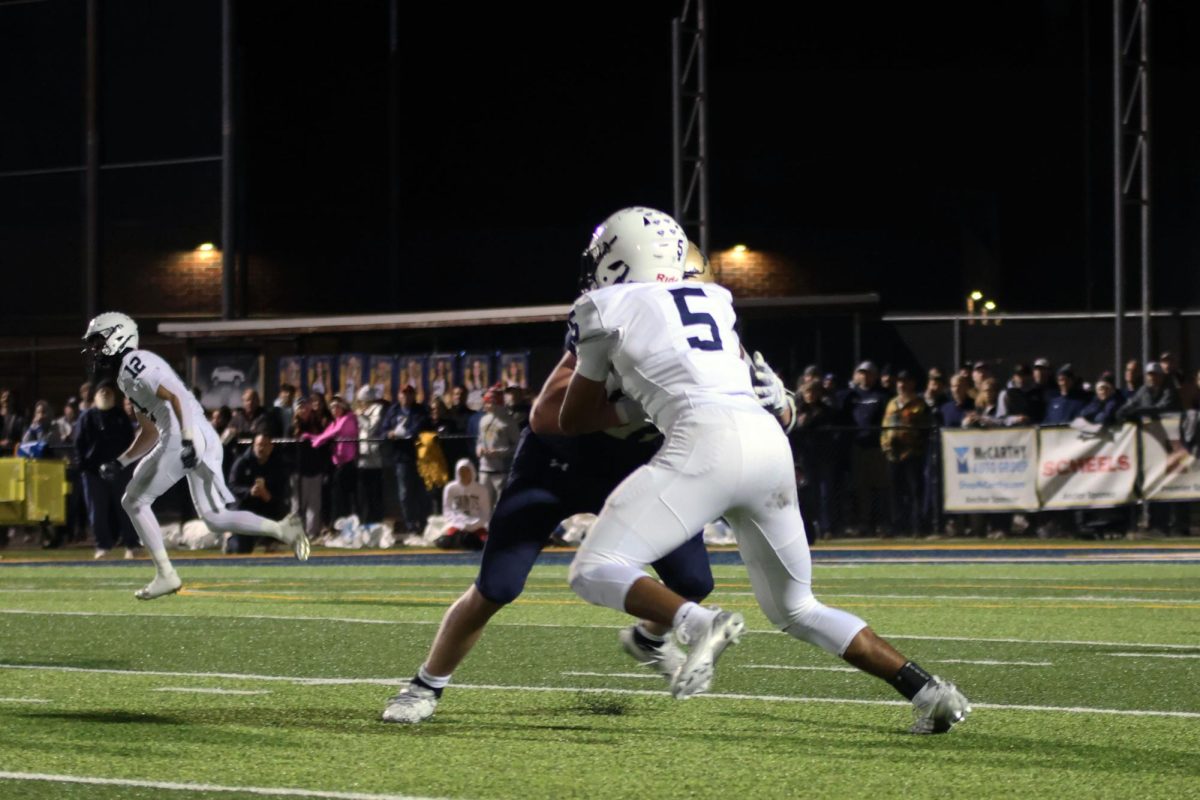 Senior Jayden Woods blocks an opposing player to help his team. 