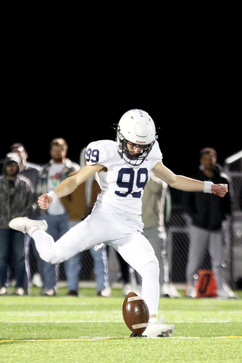 Senior Aiden Standley kicks the ball to start the second half.