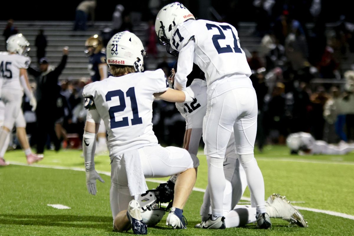 Senior Clayton Sondgeroth and junior Anderson Strack comfort junior Blake Jay after a devastating loss.