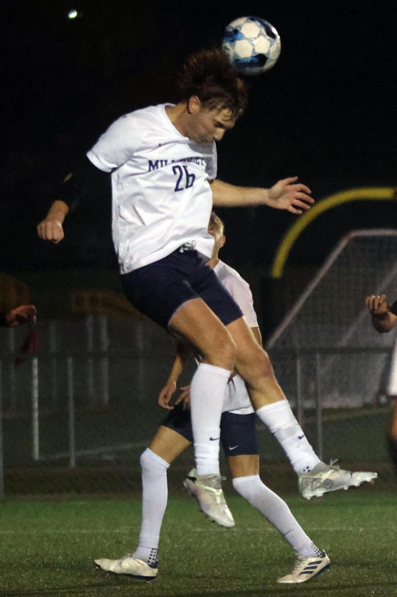 Junior Camden Dick jumps up to head the ball. 