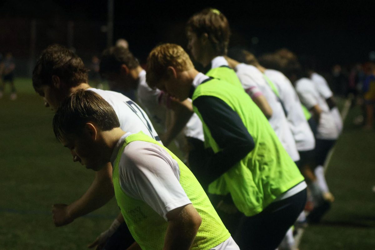 Focused, team members warm up after half time.