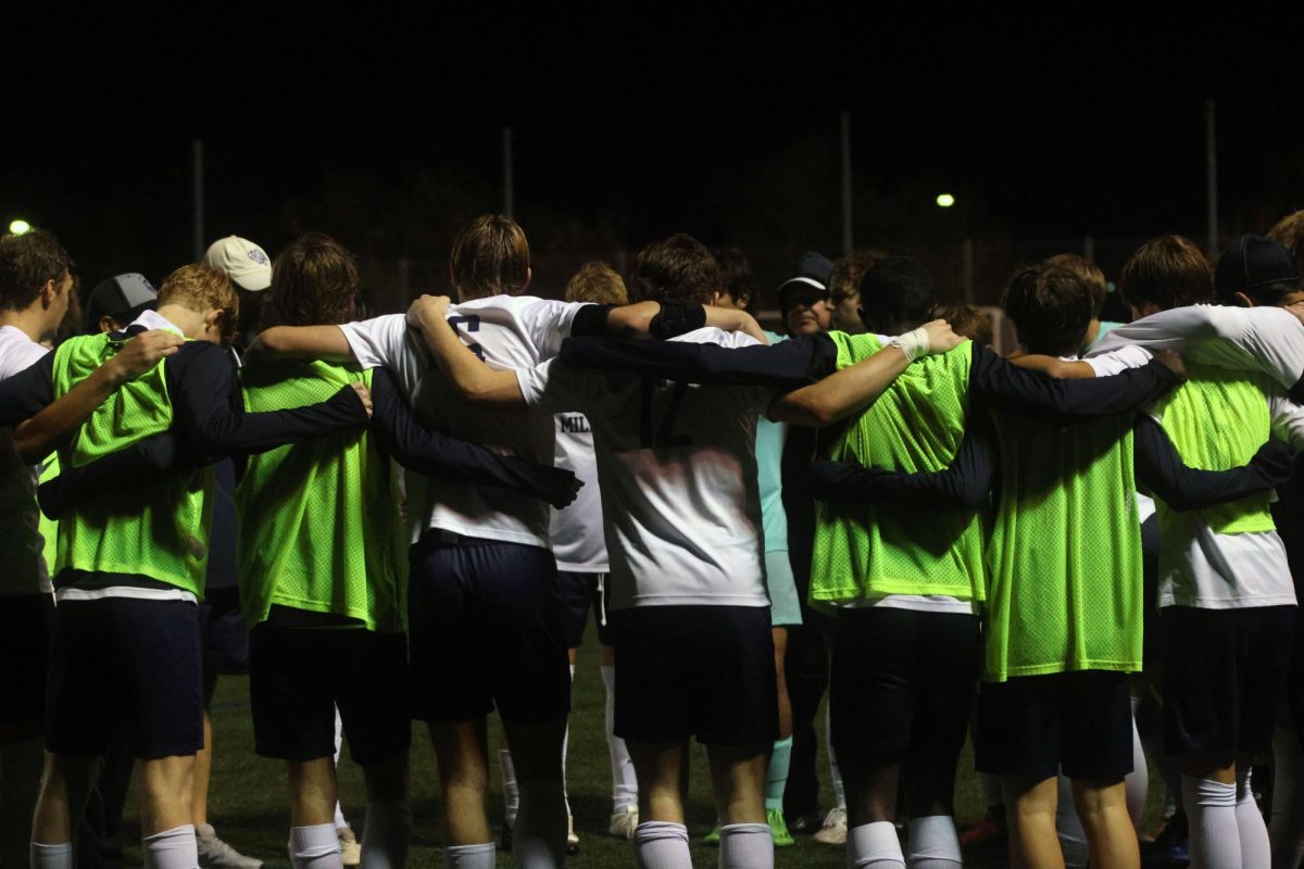 Team has a half time huddle to prepare for the second half of the game. 