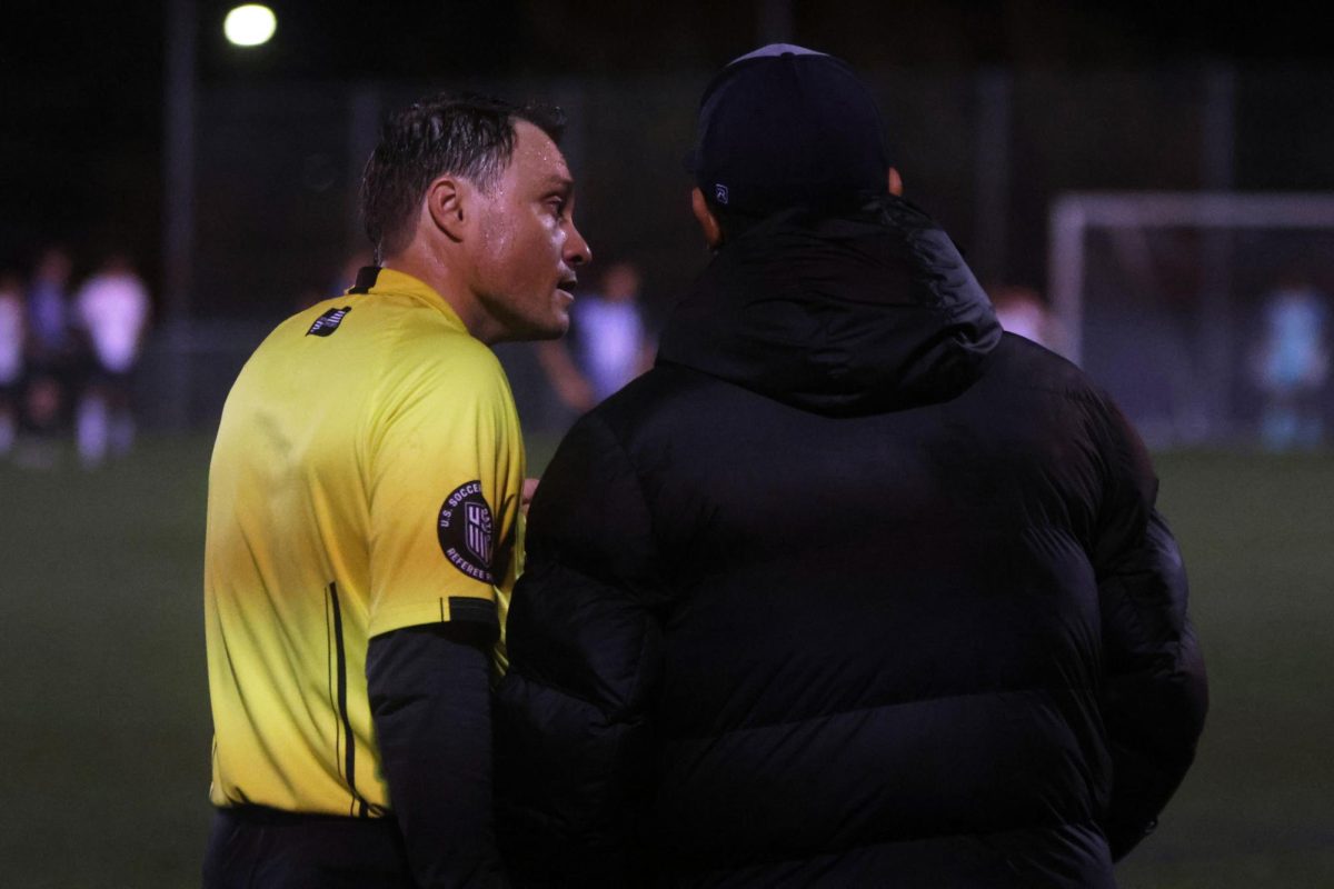 Referee explains his call to head coach Carlos Olivas. 