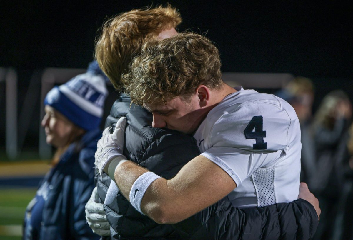 After a heartbreaking loss, senior Garret Clark hugs senior Conner Wood.