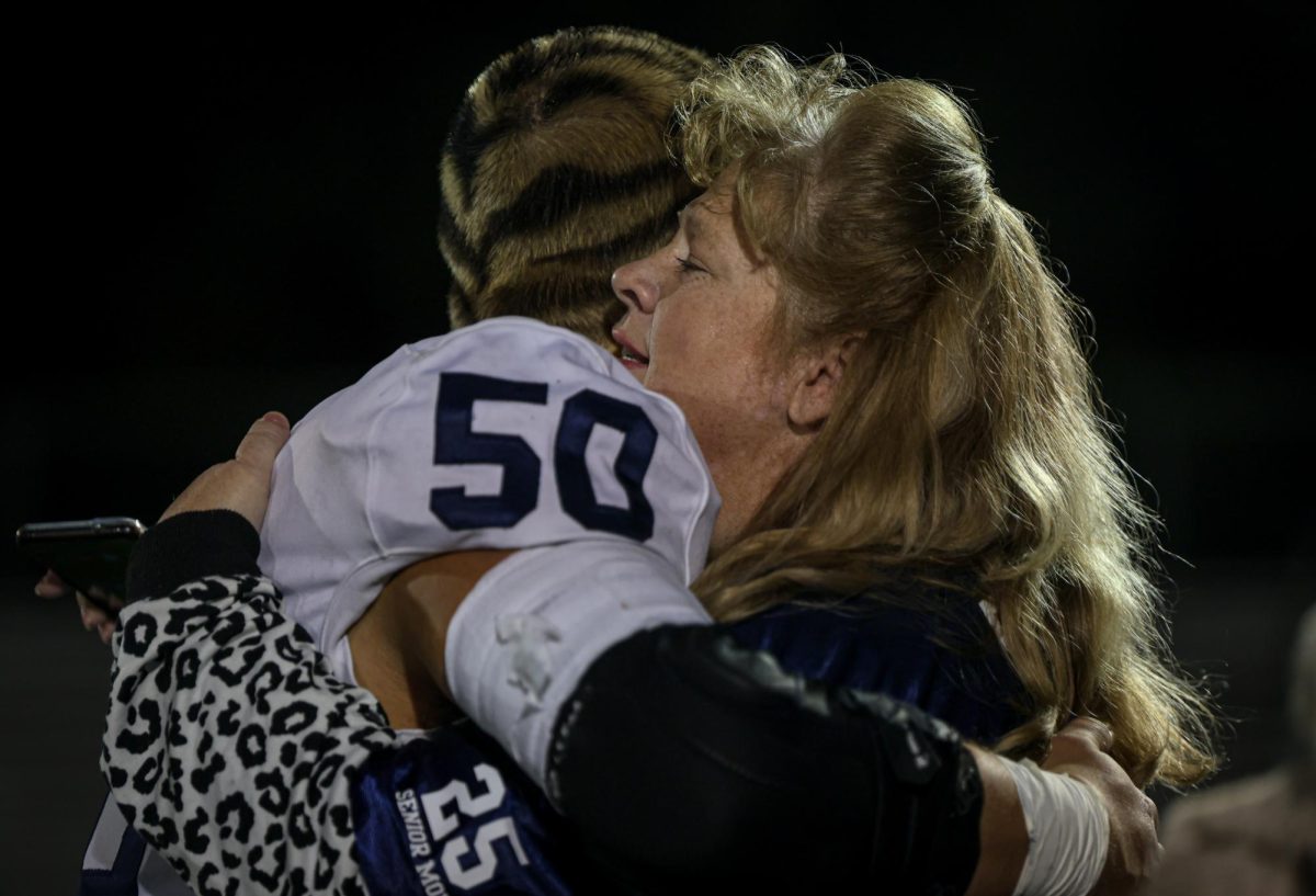 After playing his last football game ever, senior Zach Zaldivar hugs his friend's mom 