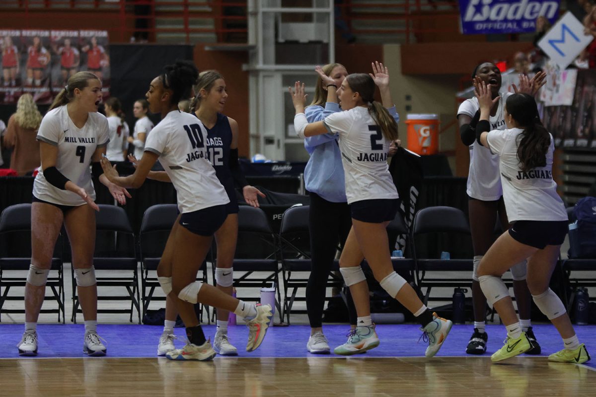 Before the match against Garden City, the team high-fives each other.