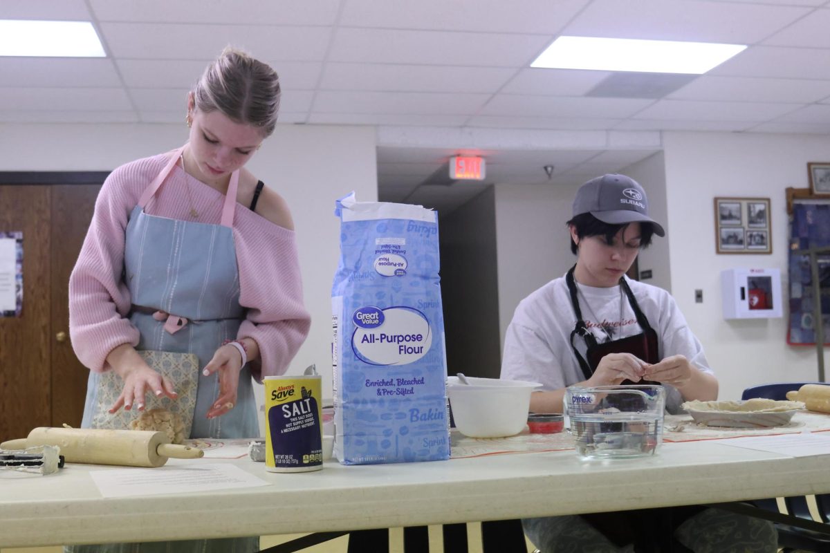 Juniors Eden Christian and Oliver Feiring knead and roll out dough to assist their fellow Girl Scouts in making pies for the Desoto Food Pantry. 
