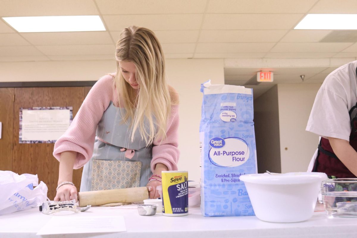 Junior Eden Christian rolls out dough to form the crust of each apple pie as the Girl Scouts prepare pies for the Desoto Food pantry. 
