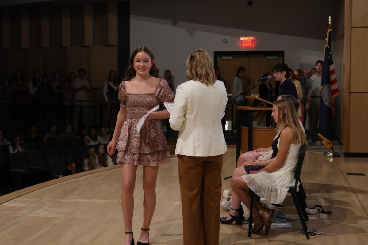 Sophomore Eliza Fleetwood walks down the stage with her certificate on Nov. 12. 