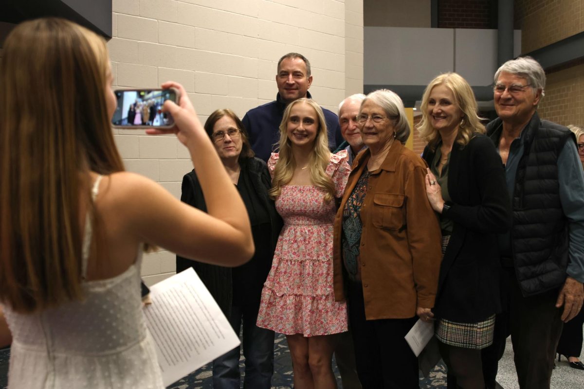 President of the National English Honor Society senior Abby Riggs poses for a photo with her family after the induction ceremony on Nov. 12.