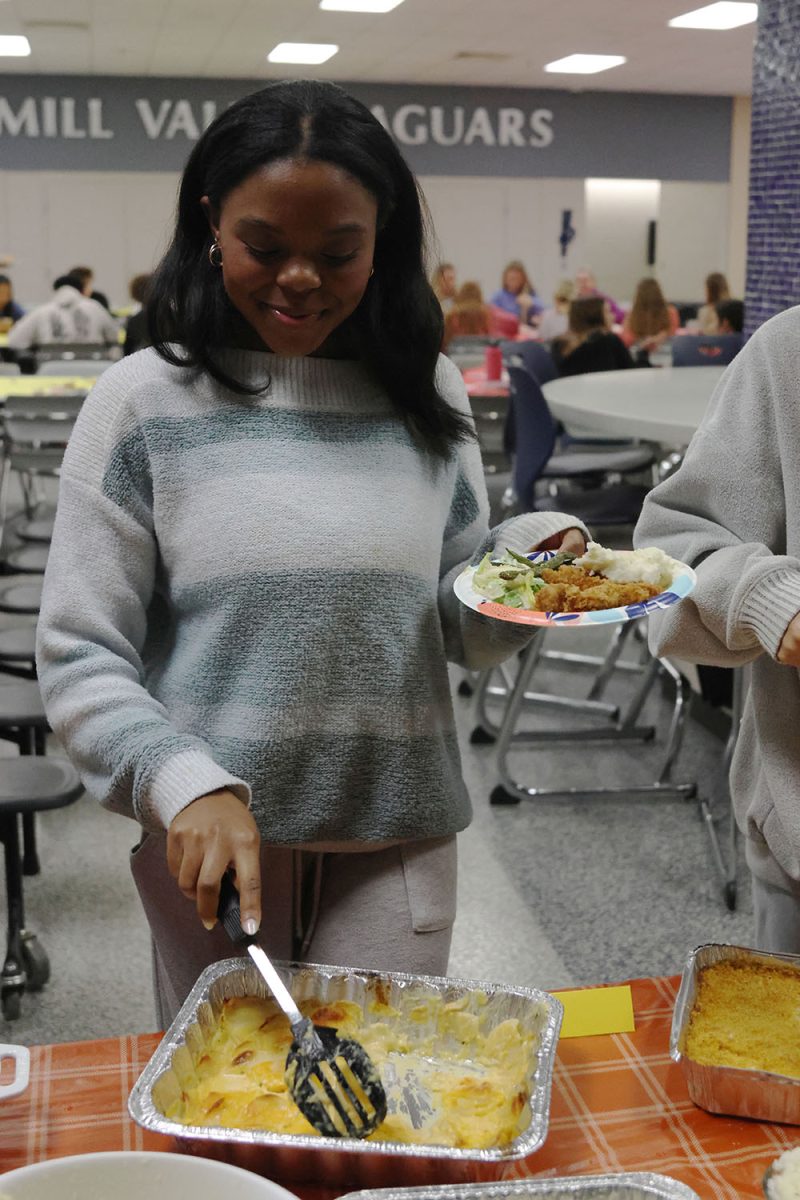 Preparing to eat, junior Tristyn Jones puts food on her plate.
