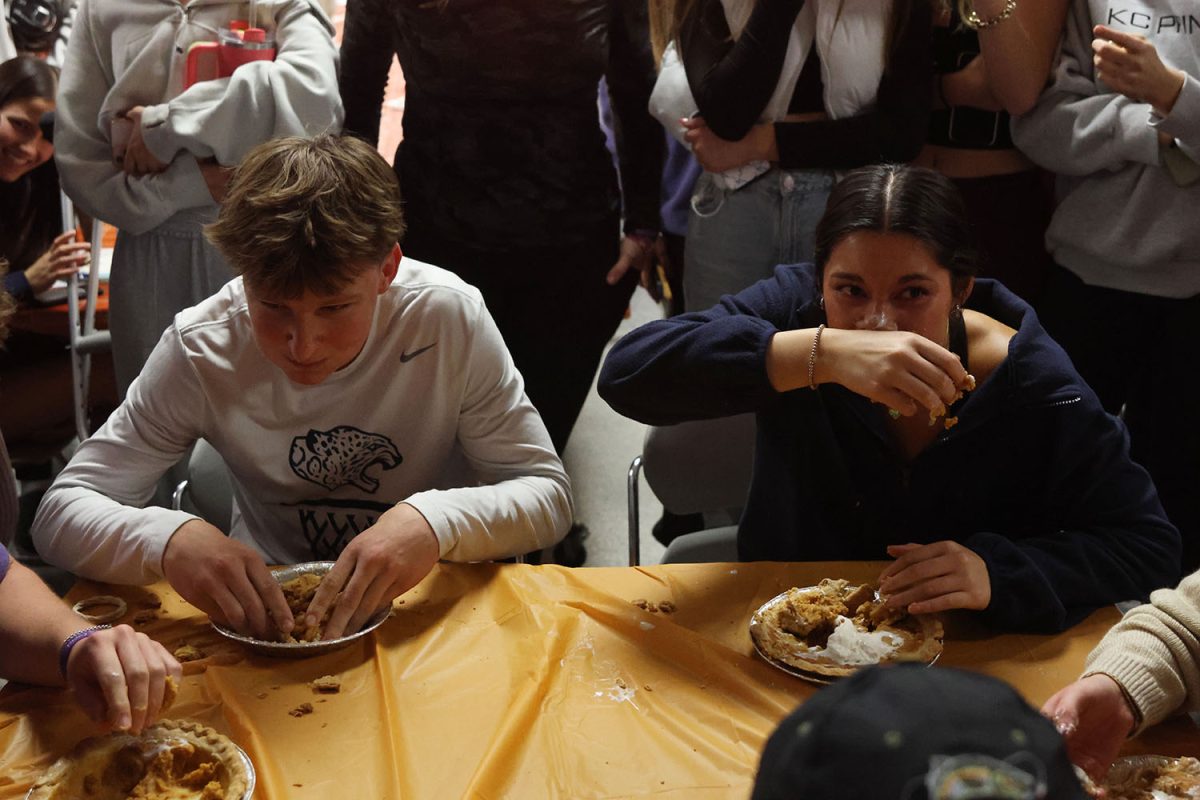 Competing against each other, juniors Grant Kuchynka and Stella Beins eat their pies.
