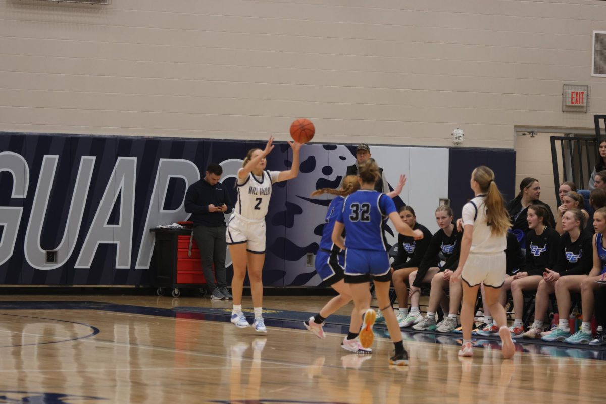 Senior Marissa Hoelting passes the ball to sophomore Riley Marshall.