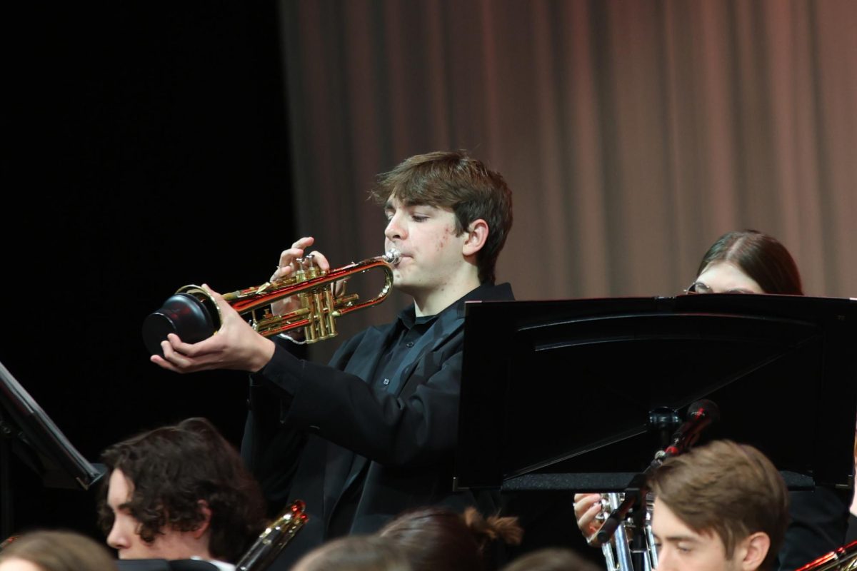 Using a cup mute, senior Carson Reynolds plays “Big Noise From Winnetka."