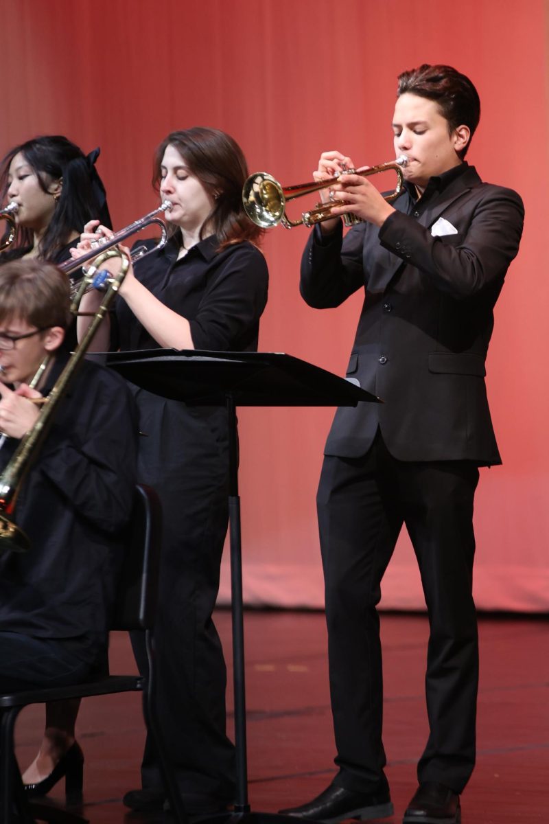 Focusing on the music, sophomore Turner Bruce plays the trumpet.