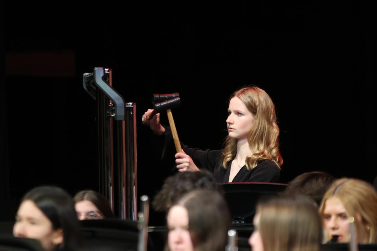 Mallets in hand, junior Jordan Powell plays the chimes in “A Christmas Tale."