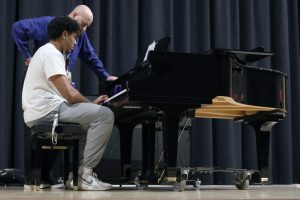 Rehearsing for his final, senior Jayden Woods gets corrections from teacher Jonathan Copeland.