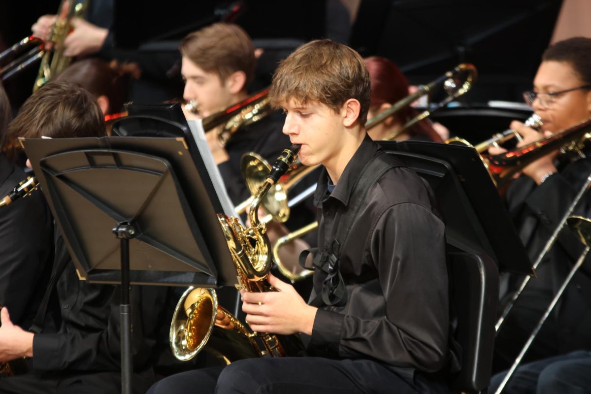 Eyes on the stand, sophomore Ethan Broxterman plays “Big Noise From Winnetka” on the saxophone.