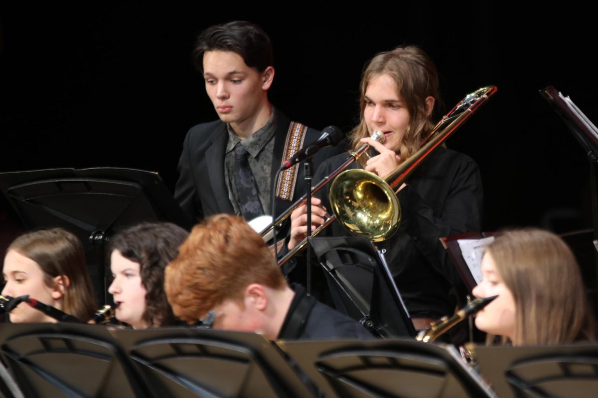 Junior Will Schieber performs his solo during “Big Noise From Winnetka” on the trombone.