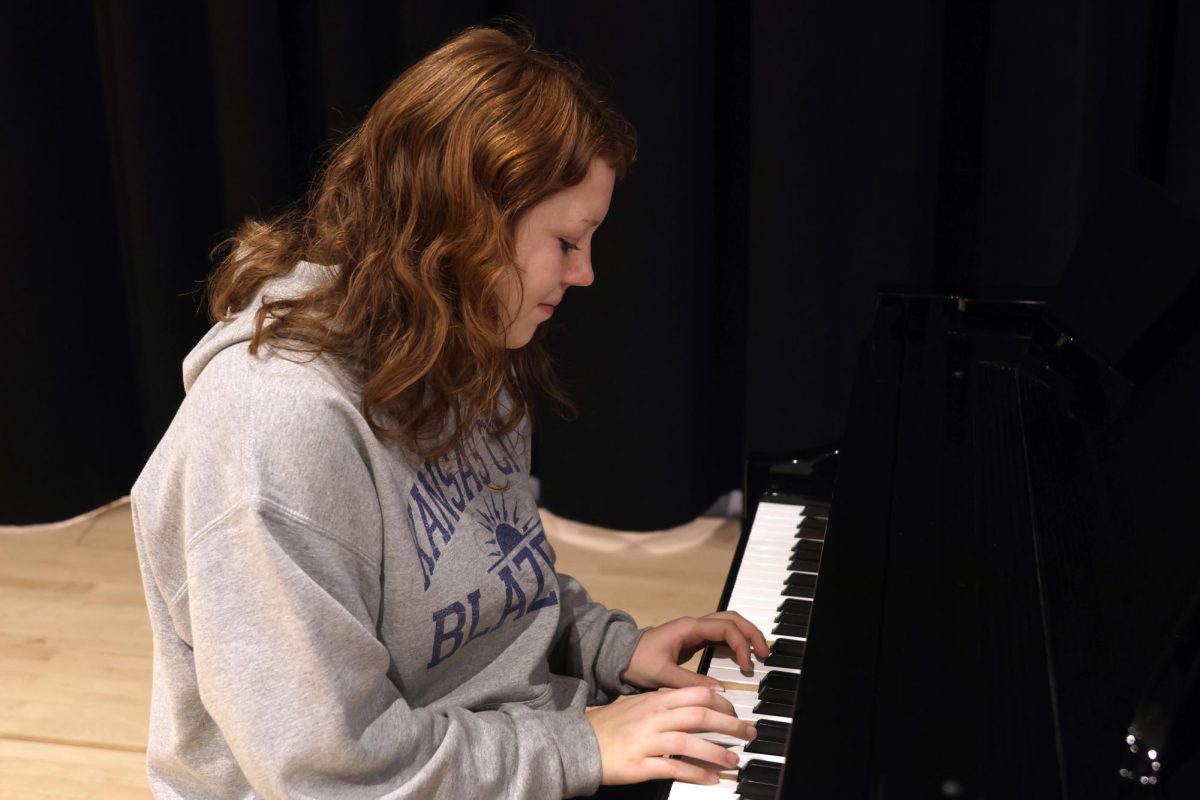 Playing the keys, sophomore Emma Cooley focuses on playing her music.