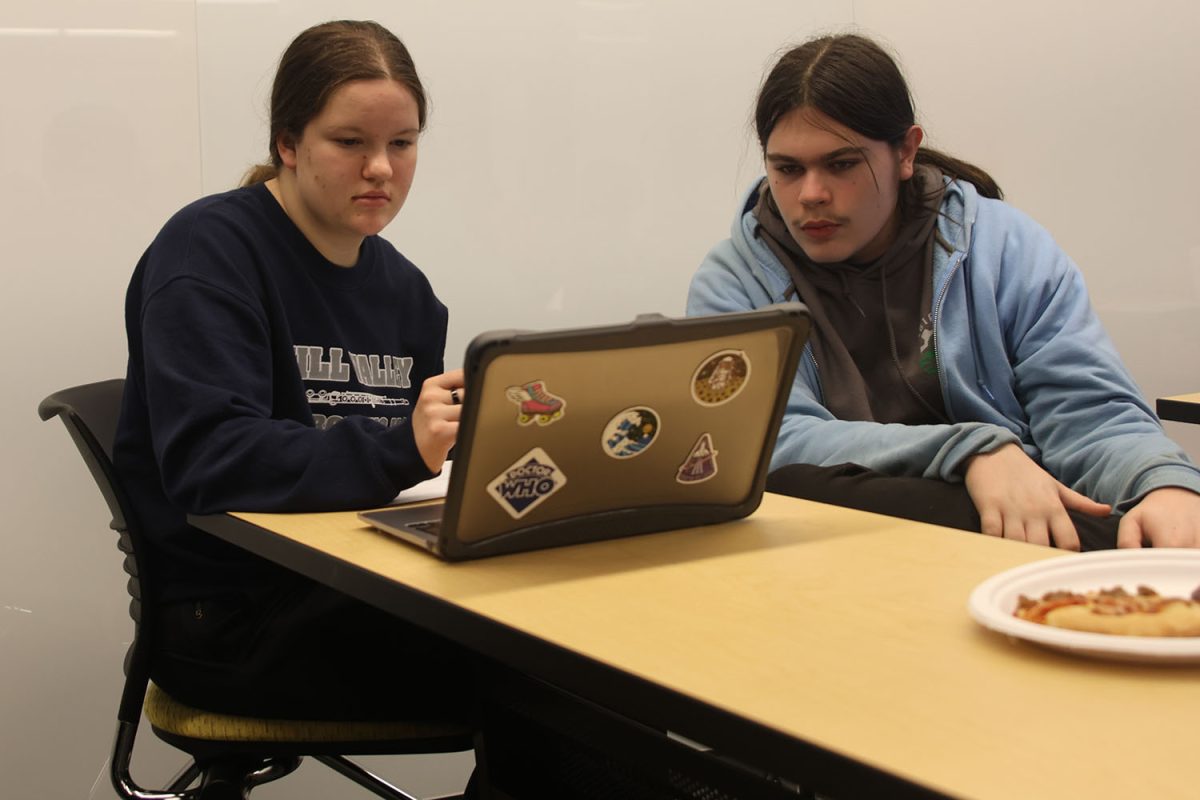 Trying to find the penalties, senior Kaitlyn Fitzpatrick and her partner search for the answers on Thursday, Dec.12.