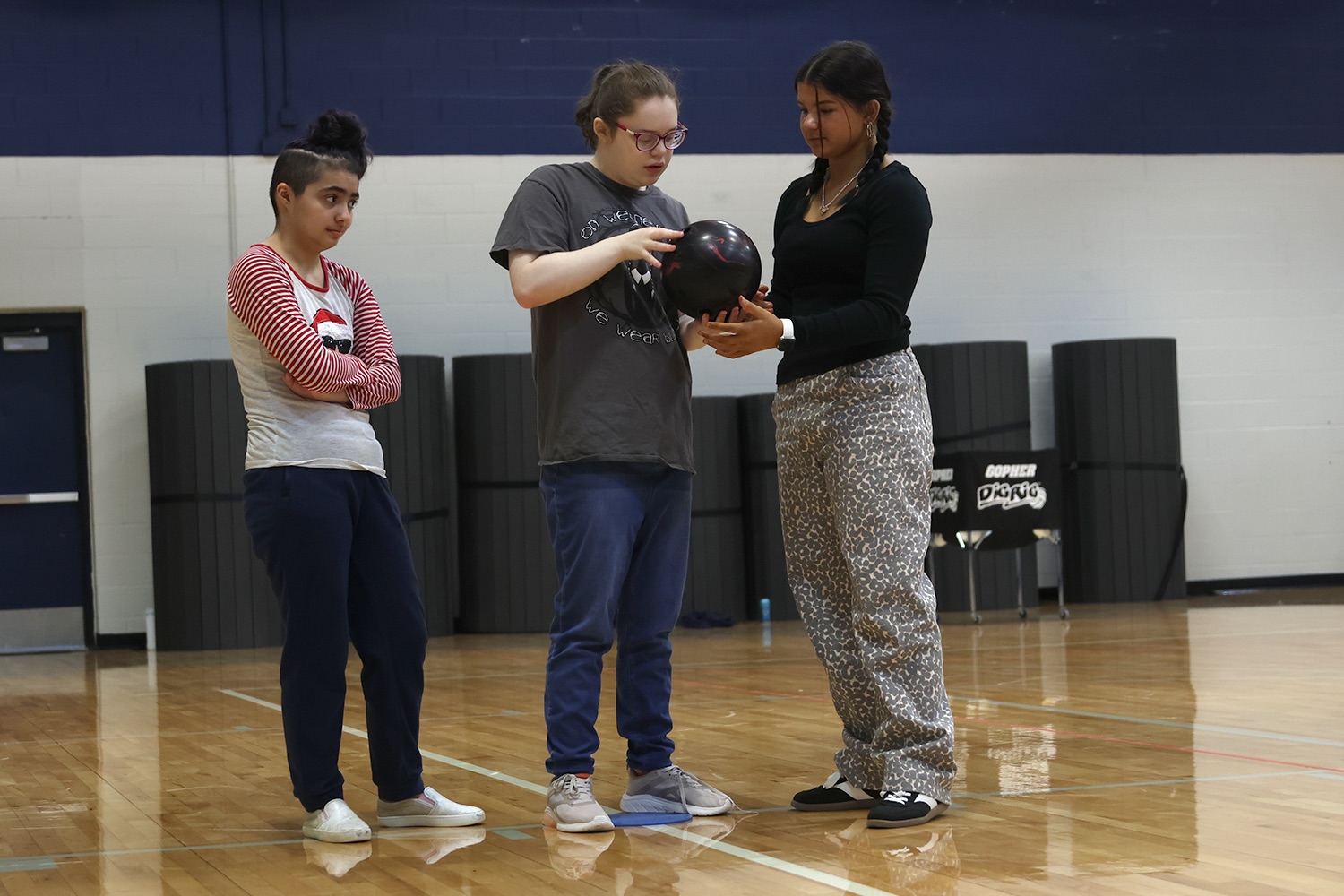 Participating in the activity, senior Robin Bishop figures out a way to master bowling with the help of junior Ava Lucht in class, Wednesday, Nov. 13.
