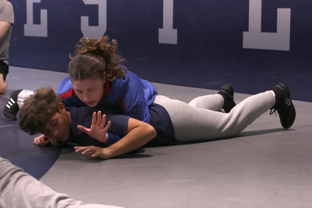 Teaching freshman CJ Olivas wrestling techniques, senior Laiyah Kirkpatrick shows where to put her hand, Tuesday Nov, 19.
