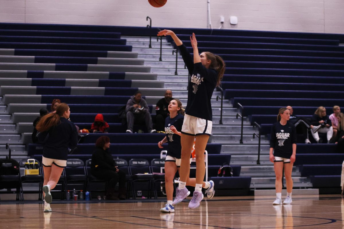 Senior Averie Landon practices her shot before the game. 