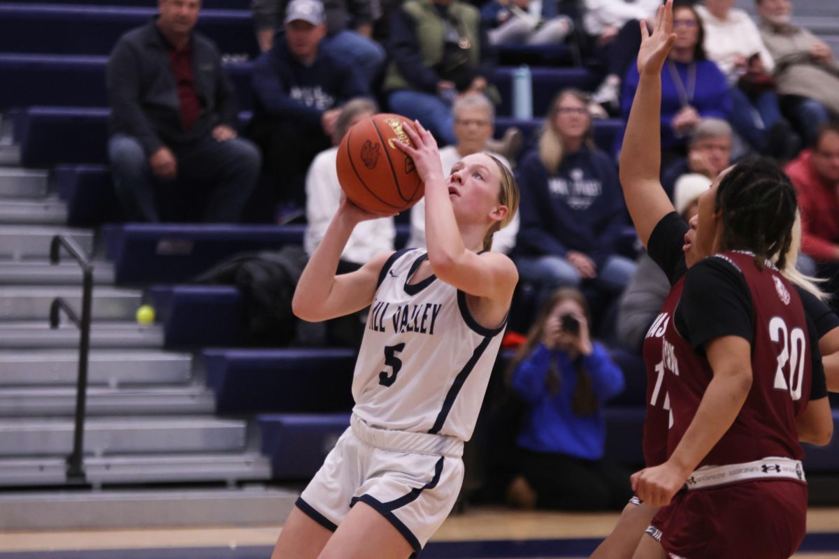 Ready to go for a layup, senior Josie Benson sets her hands on the ball. 