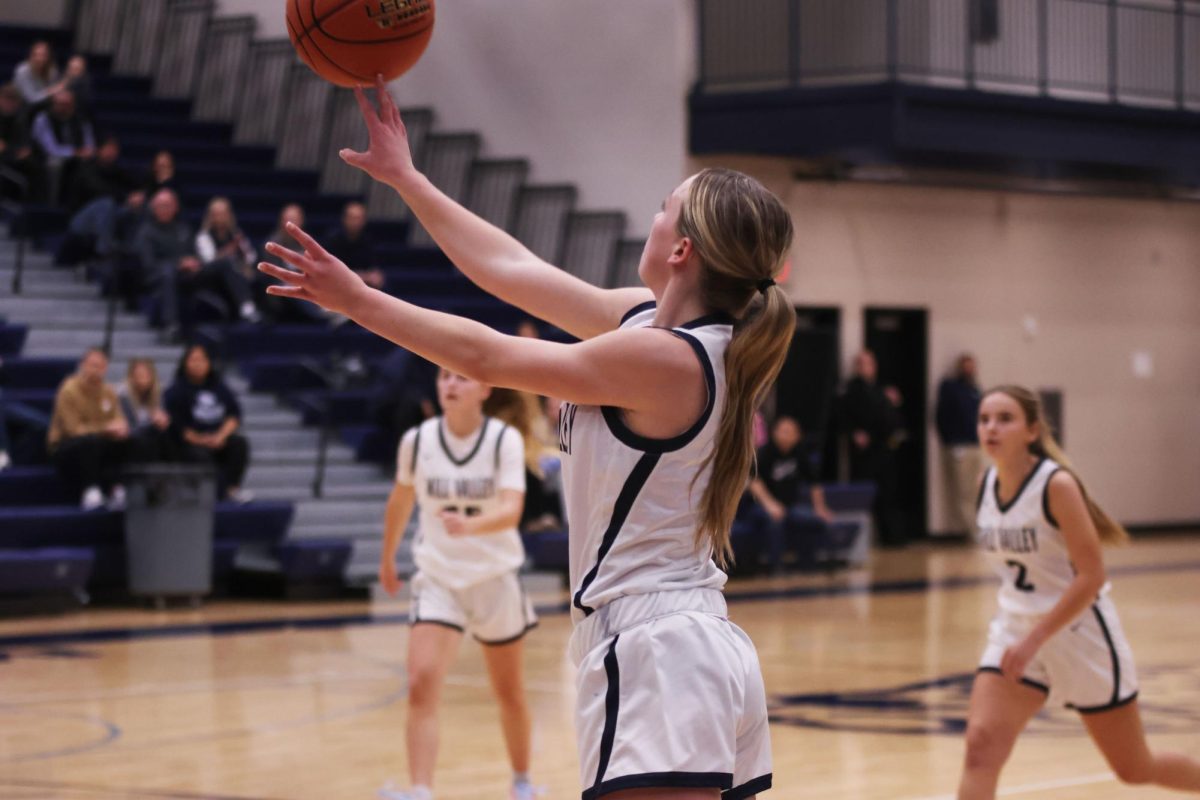 Senior Josie Benson goes for a three.