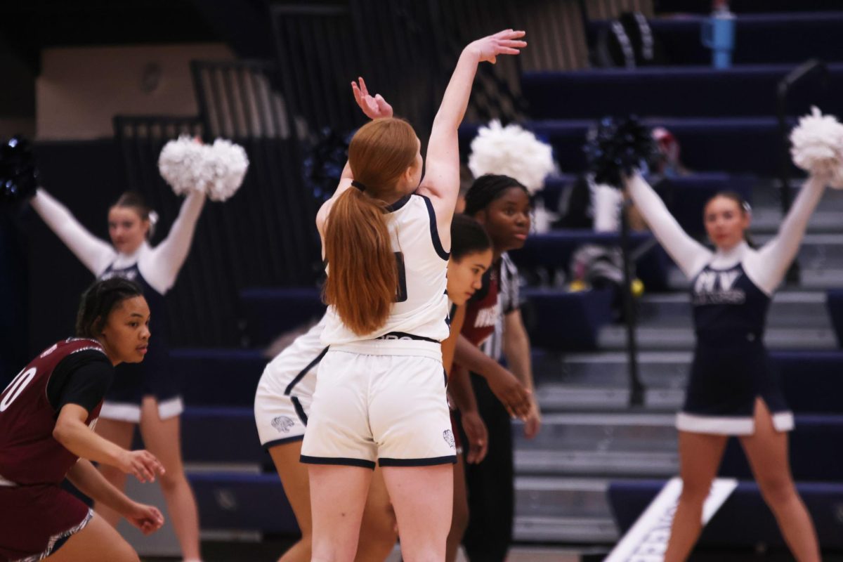 Going for the shot, junior Leah Konen keeps her hands in the air. 