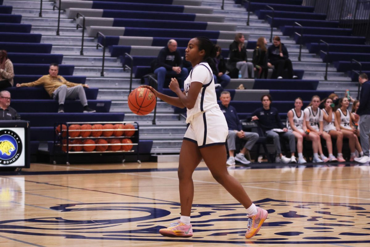 Sophomore Biti Hasabu dribbles the ball down the court towards her teammates. 