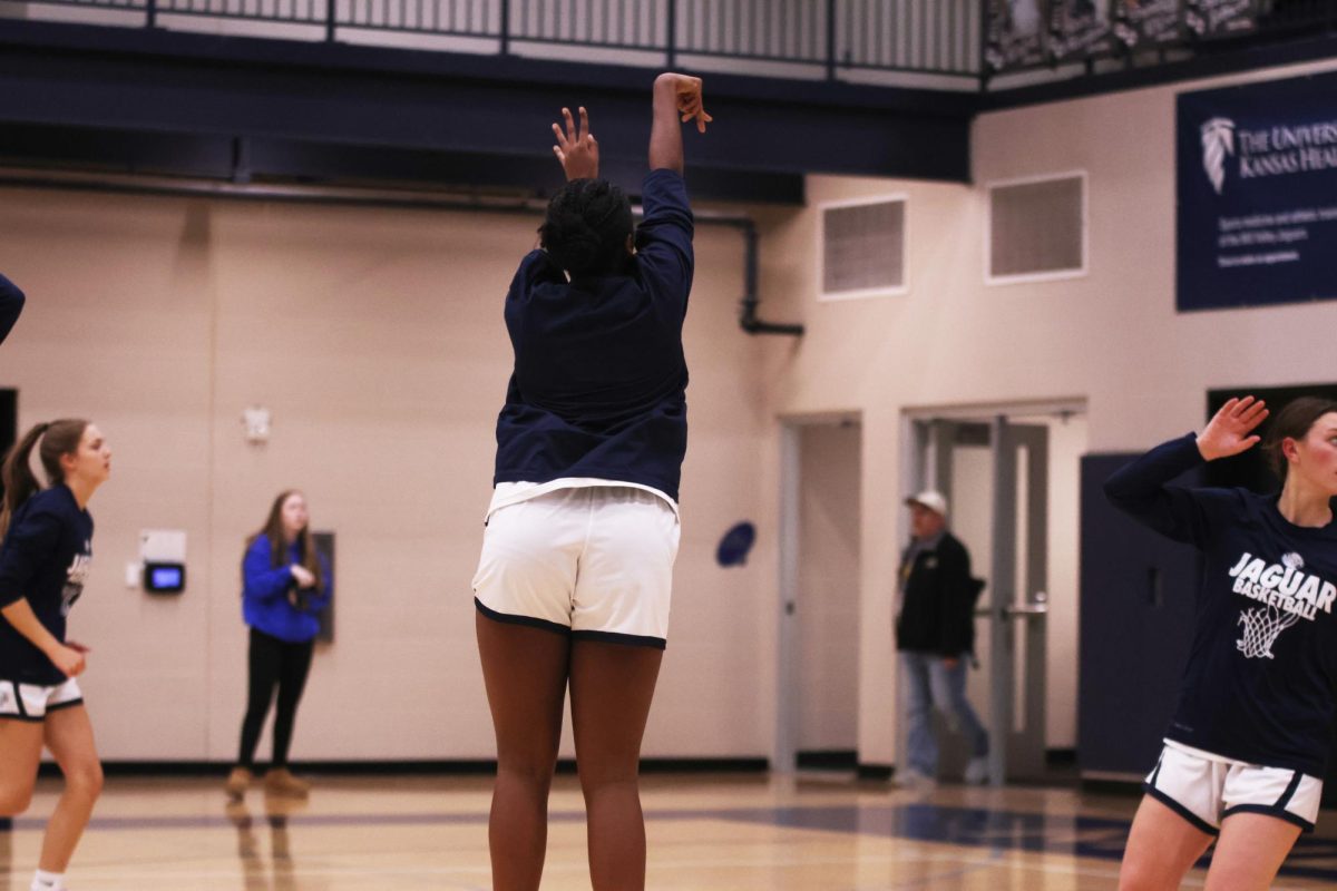 Sophomore Biti Hasabu shoots the ball before the game begins. 