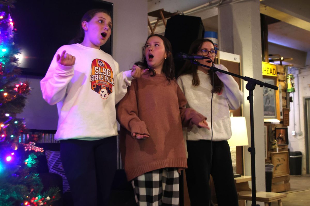 Singing "Party in The USA," by Miley Cyrus, freshman Ava Munsey, senior Reese Miller and freshman Leah Tucker hold their hands out to act out the lyrics. 