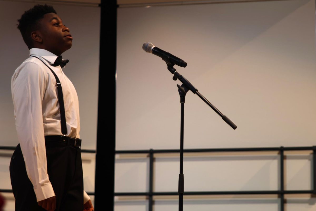 Along with several other members of the bass choir, MJ Barton sings his solo to the traditional Hanukkah song “Do Di Li”.
